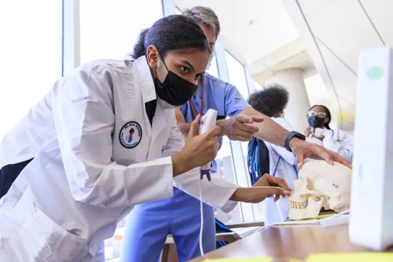 Young healthcare professional being taught a technique