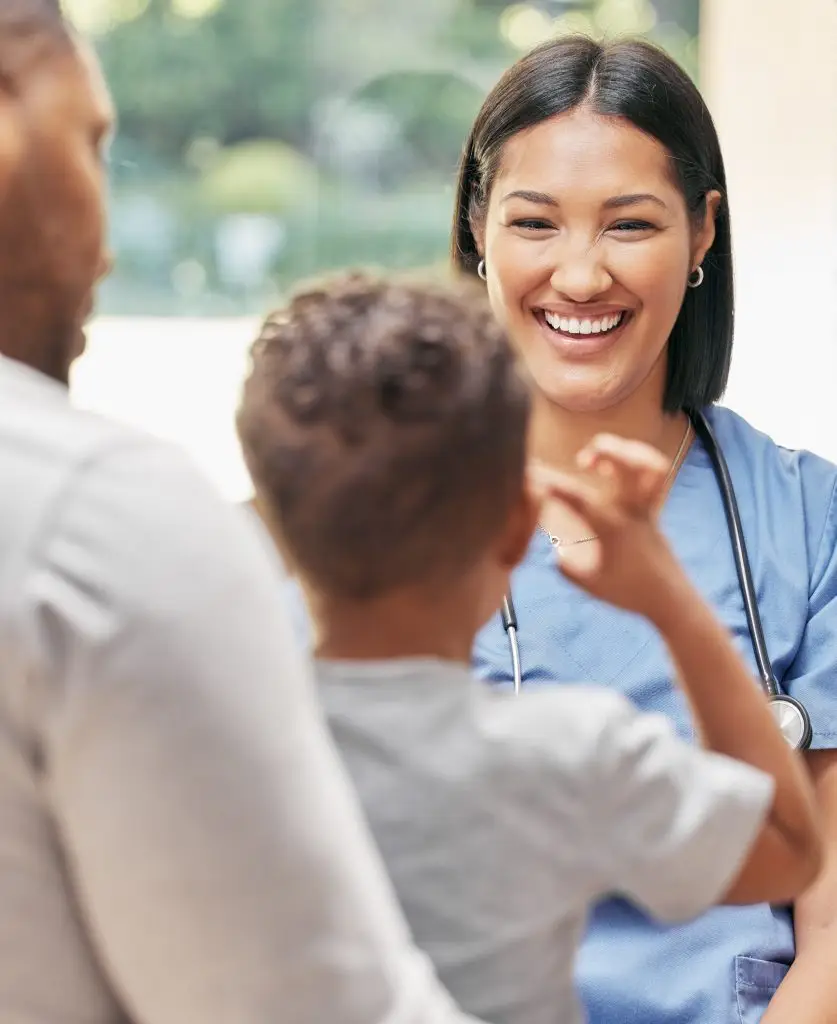 Nurse smiling at young patient