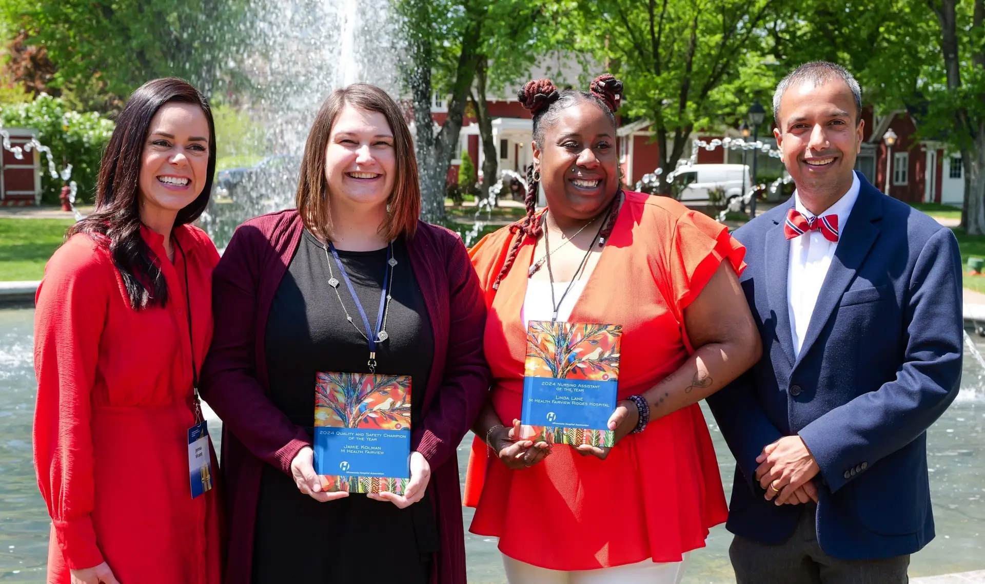 Four people stand outside at an awards reception