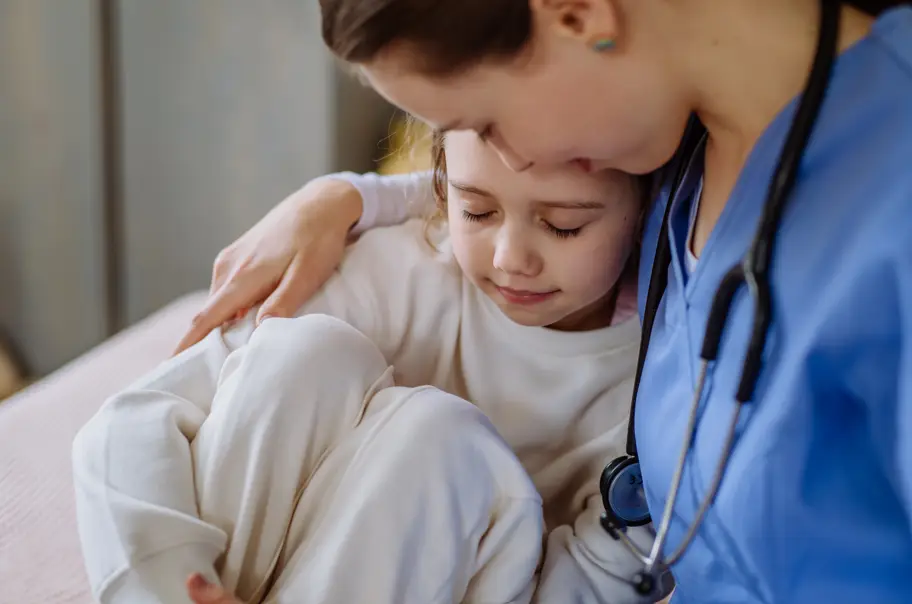 a nurse comforting a child