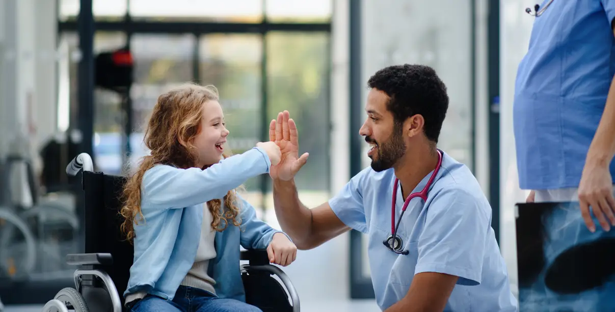 a child high fiving a care team worker
