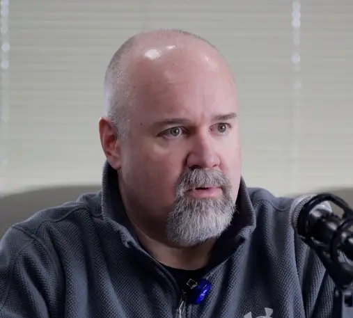 Jarrod Buresh, Medical Director at Aspirus St. Luke’s Wound Care, sits in front of a microphone for the podcast interview.