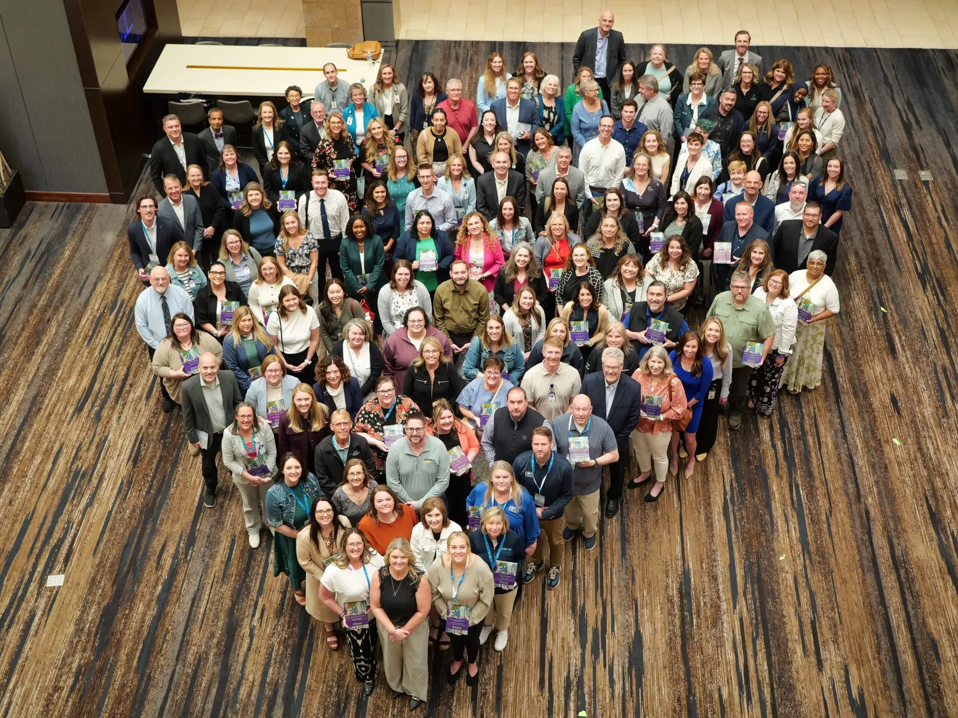 a group of 60 people holding awards