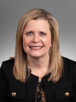 A professional headshot of a woman