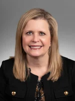 A professional headshot of a woman