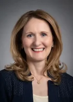 A professional headshot of a woman