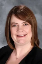 A professional headshot of a woman