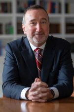 A professional headshot of a man