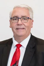 A professional headshot of a man