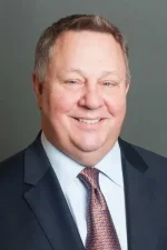 A professional headshot of a man