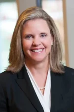 A professional headshot of a woman