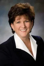 A professional headshot of a woman