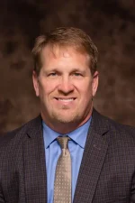 A professional headshot of a man