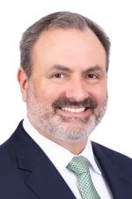 A professional headshot of a man